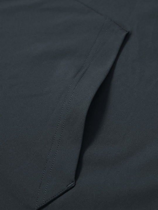 Close-up of single pocket detail on youth long sleeve hoodied with kangaroo pocket in dark grey, showing stitching.