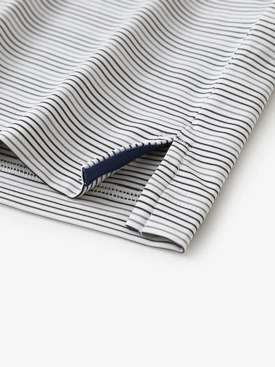 Close-up of side hem slit on Dark Grey Neutral Grey Performance Stripe Golf Shirt