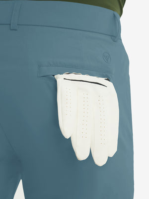 Close-up of the back pocket detail on the blue stretch soft flat front dress golf shorts, emphasizing storage