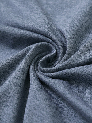 Close-up fabric detail of skin-friendly long sleeve melange polo, soft blend texture with demin blue heather tone