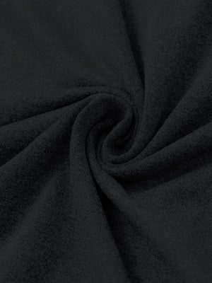 Close-up of melange fabric on quarter zip pullover, showing texture and detail in black.