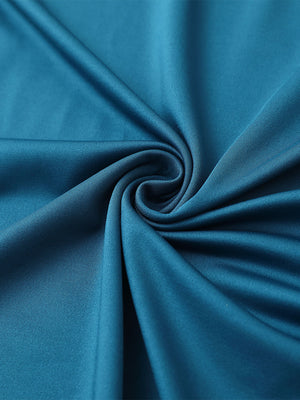 Close-up of dusty blue chest print polo shirt fabric showing smooth texture and crisp graphic application area.