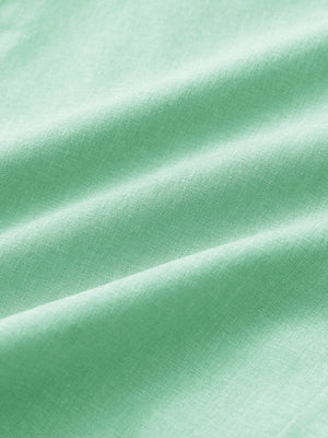 Close-up of mint green heather performance golf shorts fabric showing moisture-wicking texture.