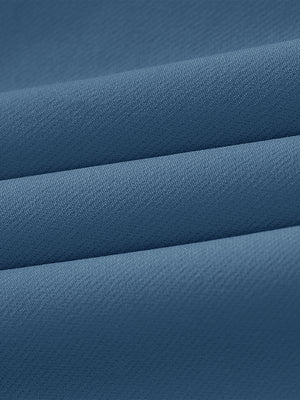 Close-up of wrinkle-resistant, sun-protective fabric on water-resistant golf stretch nylon pants in blue indigo.
