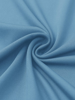 Close-up of sky blue women's performance solid polo fabric texture.