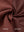 Close-up of the inside-out fabric of the reversible fleece jacket with 5 pockets in maroon.