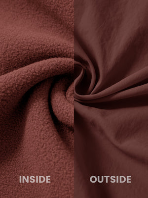 Close-up of the inside-out fabric of the reversible fleece jacket with 5 pockets in maroon.
