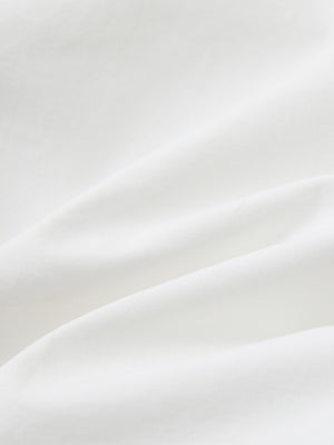 Close-up of white boys lightweight dry fit flat front golf shorts fabric texture.