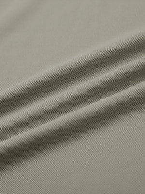Close-up of dark khaki everyday classic solid polo fabric texture.