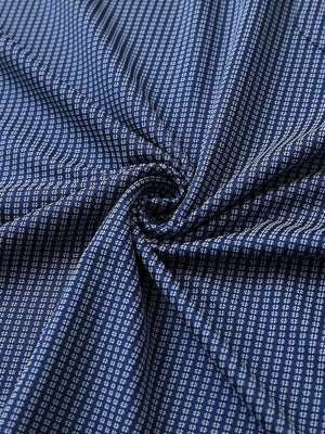 Close-up of navy elegant performance jacquard polo fabric showing refined texture and subtle pattern.