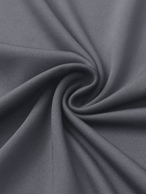 Close-up of light grey women's performance solid polo fabric texture.