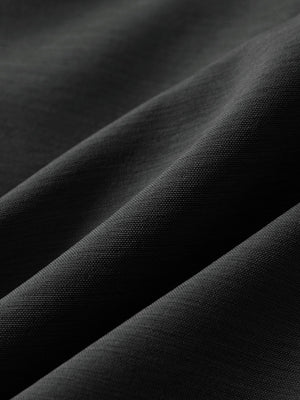 Close-up texture of dark charcoal flat front hybrid golf shorts fabric showing detailed hybrid material and weave.