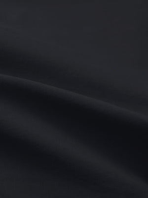 Close-up texture of black flat front flex cotton blend golf shorts fabric showing detailed cotton blend material and weave.