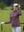 The model is wearing Women's Water-Resistant Stretch Fleece Lined Jacket light pinkish purple on the golf course.