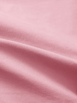 Close-up texture of pink flat front flex cotton blend golf shorts fabric showing detailed cotton blend material and weave.