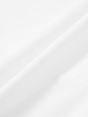 Macro view of the white stretch soft flat front dress golf shorts fabric, showcasing the smooth texture