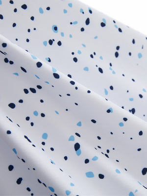 Macro view of the blue navy dot 4 way stretch print collared polo shirt fabric, showcasing the unique print design