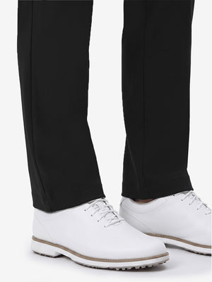 Detail view of hem and lower leg on black women's regular fit stretchy golf pants