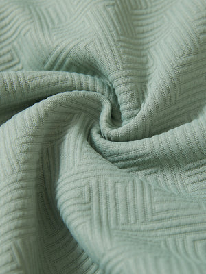 Close-up fabric detail of soft sweatpants with 4 zipper pockets, smooth texture and cozy beryl green feel