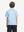 Back half-body view of youth wearing blue dinosaur performance print boys golf polo, showing rear design