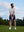 Model in light grey your favorite jacquard polo preparing to tee off, full-body shot