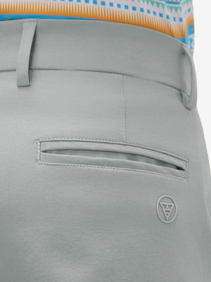 Close-up of the back pocket detail on the rose dust youth water resistant cotton blend golf pants, emphasizing storage
