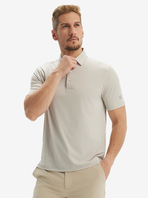 Front half-body view of a model wearing the oyster gray everyday classic solid polo, displaying the chest pocket detail
