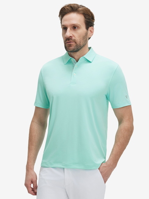Front half-body view of a model wearing the aqua blue everyday classic solid polo, displaying the chest pocket detail