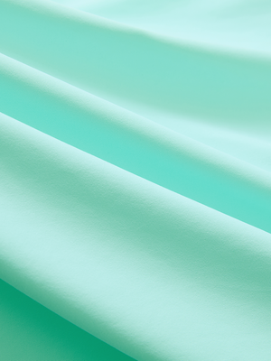 Close-up of the smooth cotton-blend fabric on the aqua blue everyday classic solid polo