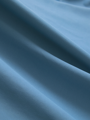 Close-up of the smooth cotton-blend fabric on the misty blue everyday classic solid polo