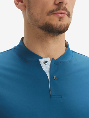 Close-up of model in blue moisture-wicking short sleeve henley shirt, nose to chest front view.