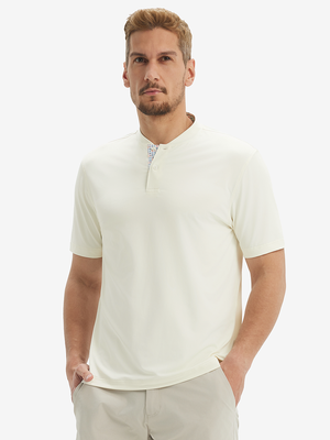 Front half-body view of model wearing cream moisture-wicking short sleeve henley shirt